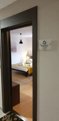 a door leading to a bedroom with a bed at Apartment Story,Nikole Cupica Beograd in Belgrade