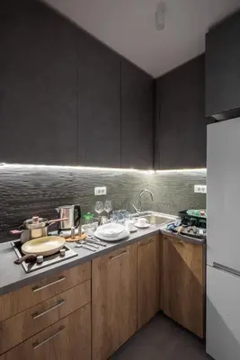 a kitchen with wooden cabinets and a counter top at Belly 1 in Vračar (historical)