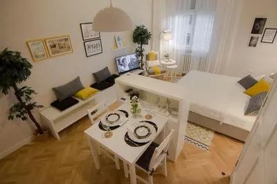 a small living room with a bed and a table at Studio Stil in Belgrade