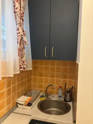 a kitchen counter with a sink and a cabinet at Bella Centre Apartment in Belgrade
