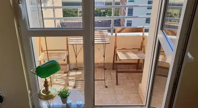 a view of a balcony with a green lamp and a chair at Bella Vita Apartment in Belgrade