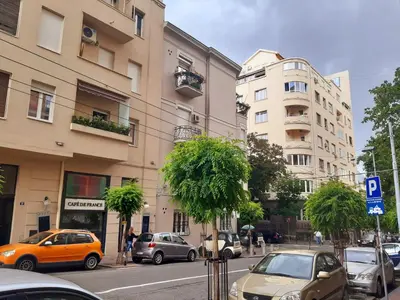 a city street with cars parked on the street at Bella Vita Apartment in Belgrade