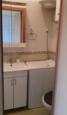 a small bathroom with a sink and a toilet at Bella Vita Apartment in Belgrade