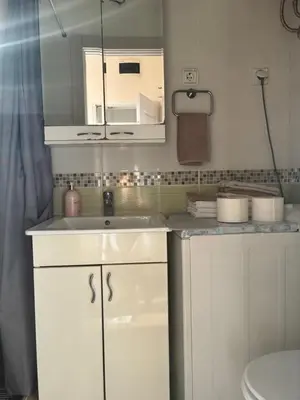 a white bathroom with a sink and a toilet at Bella Vita Apartment in Belgrade