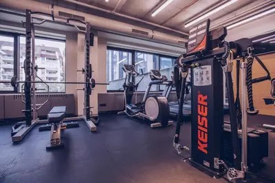 a gym with several treadmills and cardio machines at Hotel Mona Plaza in Belgrade