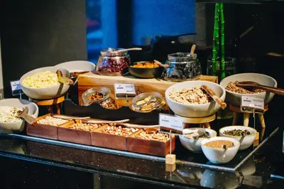 a buffet with different types of food on a table at Hotel Mona Plaza in Belgrade