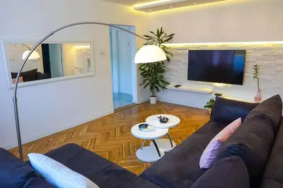 a living room with a couch and a table at Apartment De Luna Belgrade in Belgrade