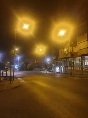an empty parking lot at night with street lights at Apartment De Luna Belgrade in Belgrade