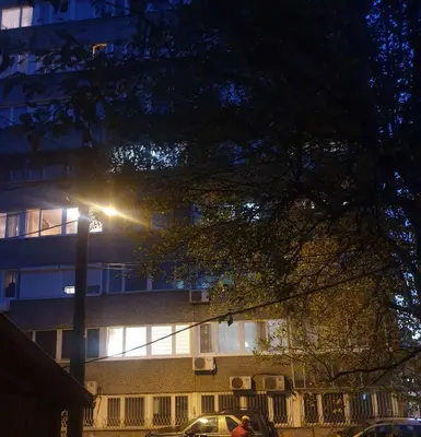 a street light in front of a building at night at Apartment De Luna Belgrade in Belgrade