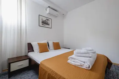a bedroom with a bed with towels on it at Villa Bulevar in Belgrade