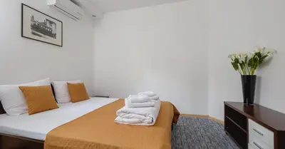 a bedroom with a bed with towels on it at Villa Bulevar in Belgrade