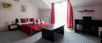 a hotel room with a bed with a red blanket at Villa Bulevar in Belgrade