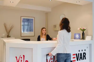 a woman standing at a counter in a hair salon at Villa Bulevar in Belgrade