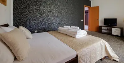 a bedroom with a large bed with white towels on it at Villa Bulevar in Belgrade