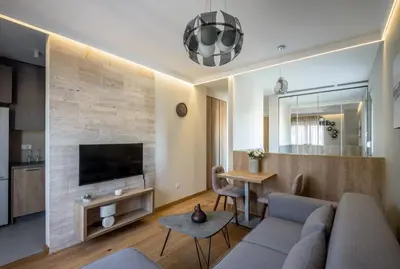 a living room with a couch and a tv and a table at Belly2 in Vračar (historical)