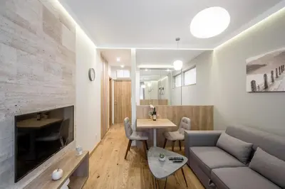 a living room with a couch and a table at Belly2 in Vračar (historical)