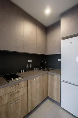 a kitchen with wooden cabinets and a white refrigerator at Belly2 in Vračar (historical)