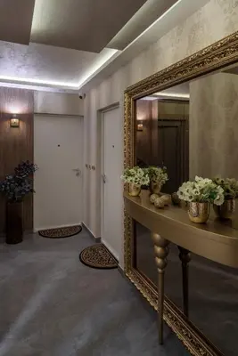 a hallway with a mirror and a table with flowers at Belly2 in Vračar (historical)