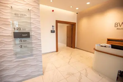 a lobby of a building with a sign on the wall at Belgrade Waterfront GREEN Apartment in Belgrade