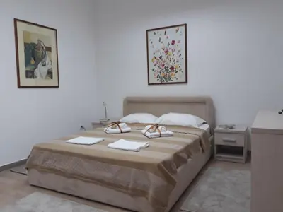a bedroom with a bed with two towels on it at Apartman Karadjordje in Zvezdara