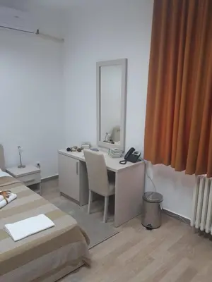 a white room with a desk and a mirror at Apartman Karadjordje in Zvezdara