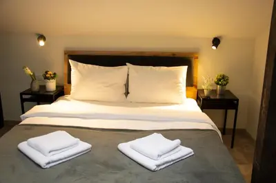 a bedroom with a bed with two towels on it at Urban Lodge Belgrade in Belgrade