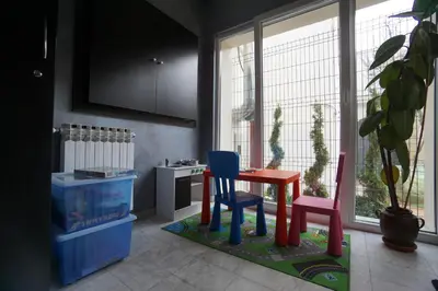 a room with a table and two chairs in front of a window at Urban Lodge Belgrade in Belgrade