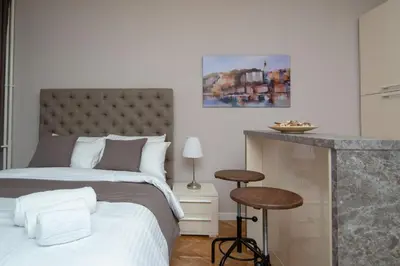 a bedroom with a bed and a table and a counter at Vracar Vuk 2 in Belgrade
