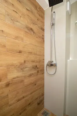 a bathroom with a wooden wall at Vracar Vuk 2 in Belgrade