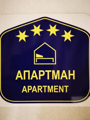 a blue sign for an apartment apartment with stars on it at Vracar Vuk 2 in Belgrade