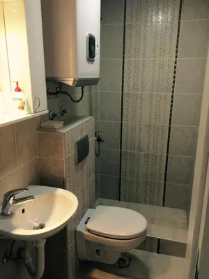 a bathroom with a toilet and a sink and a shower at Park Srce Apartments in Arandjelovac
