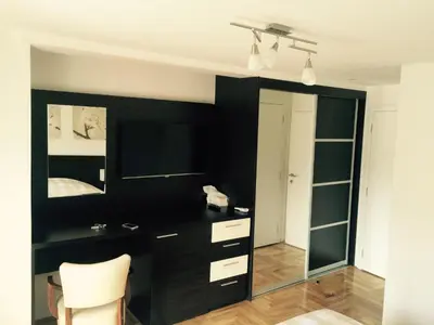 a bedroom with a black wall and a mirror at Park Srce Apartments in Arandjelovac