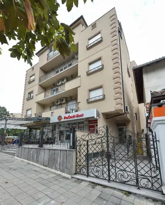 a building with a fence in front of it at Park Srce Apartments in Arandjelovac