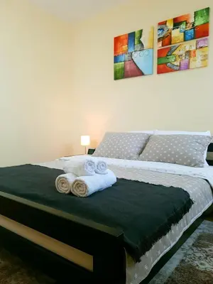 a bedroom with a bed with two towels on it at Apartman Harmony in Smederevo