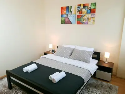 a bedroom with a bed with two towels on it at Apartman Harmony in Smederevo