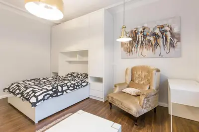 a bedroom with a bed and a chair at Belgrade Center Apartment Slavija Square II in Belgrade