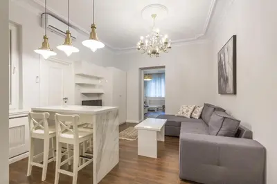 a living room with a couch and a table in a room at Belgrade Center Apartment Slavija Square II in Belgrade