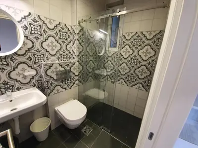a bathroom with a toilet and a sink and a shower at Belgrade Center Apartment Slavija Square III in Belgrade