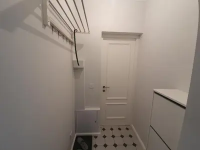 a hallway with a white door and a tiled floor at Belgrade Center Apartment Slavija Square III in Belgrade