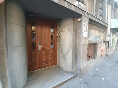 a wooden door on the side of a building at Belgrade Center Apartment Slavija Square III in Belgrade