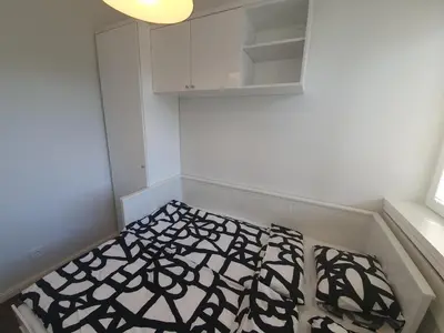 a small room with a bed and a cabinet at Belgrade Center Apartment Slavija Square III in Belgrade