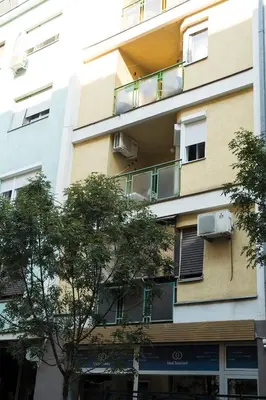 an apartment building with a balcony on the side of it at White Night City Center Apartman in Belgrade