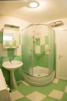 a bathroom with a shower and a sink at White Night City Center Apartman in Belgrade