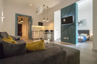 a living room with a couch and a room with a bedroom at Twin Center Apartments in Belgrade