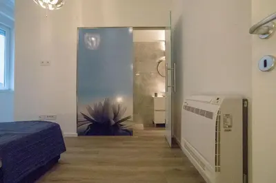 a room with a door to a bedroom with a plant at Twin Center Apartments in Belgrade