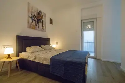 a bedroom with a bed and a table and a window at Twin Center Apartments in Belgrade