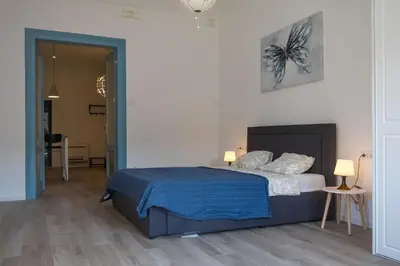 a bedroom with a bed with blue sheets and pillows at Twin Center Apartments in Belgrade