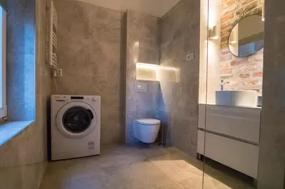 a bathroom with a washing machine and a sink at Twin Center Apartments in Belgrade