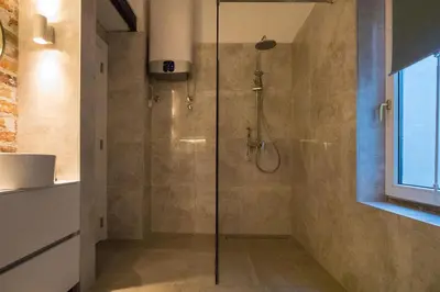 a shower with a glass door in a bathroom at Twin Center Apartments in Belgrade