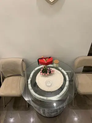 a glass table with a red purse and flowers on it at Apartman Nina BANOVO BRDO in Belgrade